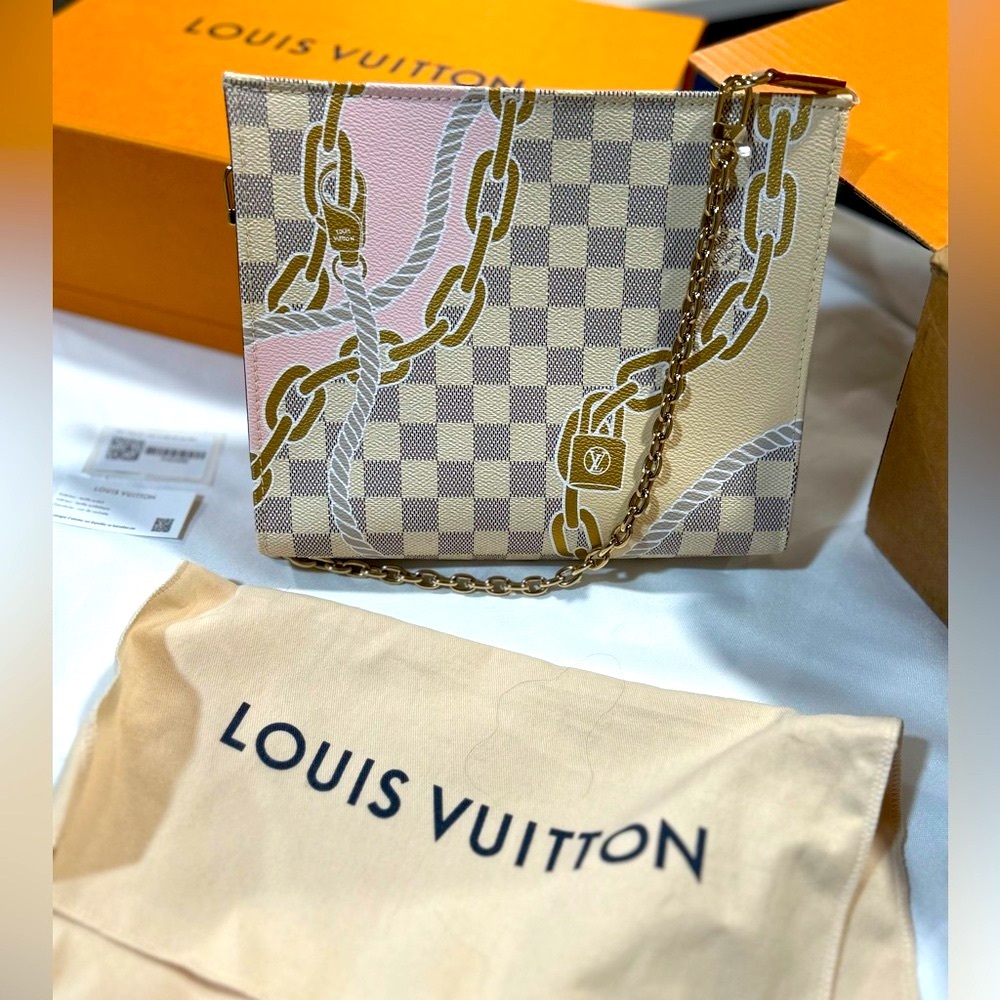 Brand new LOUIS VUITTON nautical toiletry bag with a beautiful gold chain